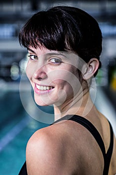 Portrait of a woman swimmer looking the camera