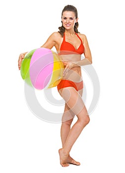 Portrait of woman in swimsuit with beach ball