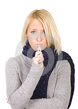 Portrait of woman taking her temperature.