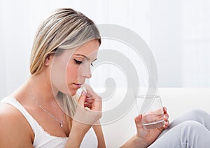 Portrait of woman taking pills