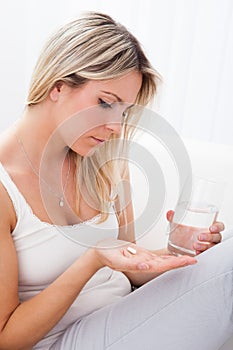 Portrait of woman taking pills