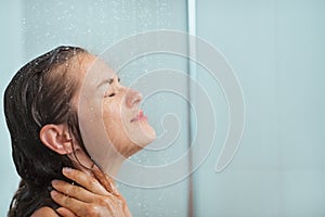 Portrait of woman taking shower photo