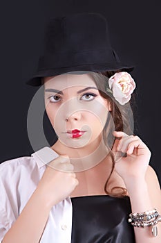 Portrait of the woman with a theatrical makeup on black background