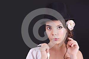 Portrait of the woman with a theatrical makeup on black background