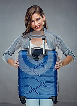 portrait of woman traveler holding big case.