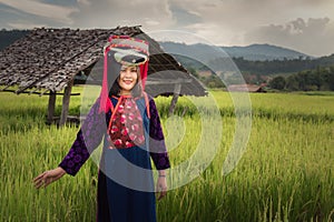 Portrait of woman tribal Lisu in traditional dress and jewelry costume in rice fields., Lifestyle of hill tribe girl in the north
