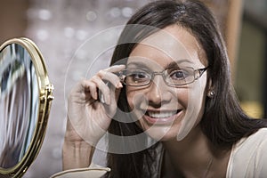 Portrait Of A Woman Trying On New Spectacles At Shop