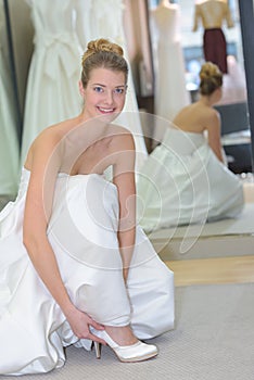 Portrait woman trying on wedding shoes