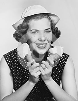 Portrait of woman with two ice cream cones