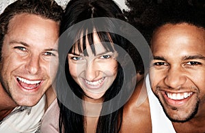 Portrait of woman with two multiethnic male friends