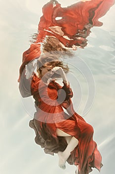 Portrait of a woman underwater in light colors