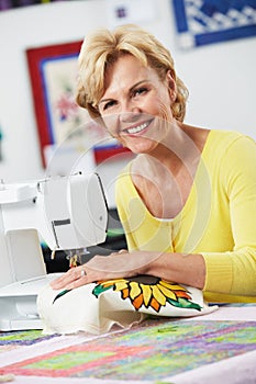 Portrait Of Woman Using Electric Sewing Machine