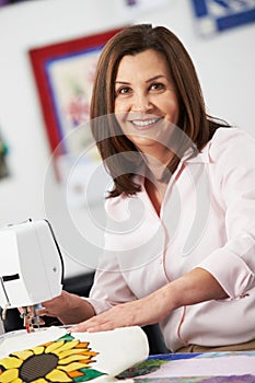 Portrait Of Woman Using Electric Sewing Machine