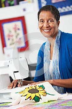 Portrait Of Woman Using Electric Sewing Machine