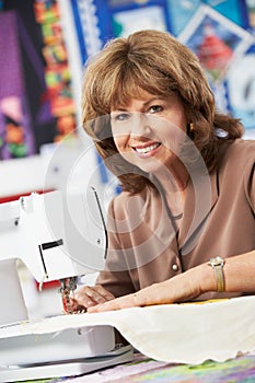 Portrait Of Woman Using Electric Sewing Machine