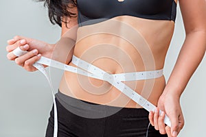 Portrait of woman using scale tape measuring waist, Healthy and