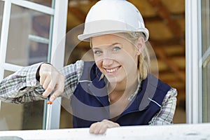 portrait woman using screwdriver at open windows