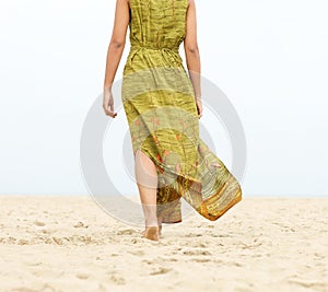 Portrait of a woman walking barefoot at the beach