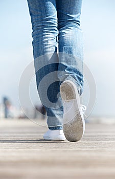 Portrait of a woman walking outdoors in comfortable white shoes