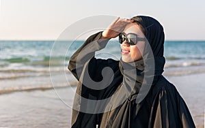 Portrait of a woman in abaya on the beach photo