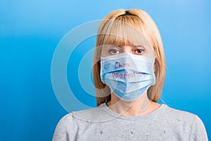 Portrait of a woman wearing medical mask with China quarantine word at blue background. and healthcare concept