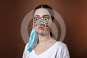 Portrait of a woman wearing protective mask with a QR code instead of a face. Brown background. The concept of