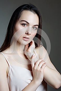 Portrait of woman in white blouse and black hair.