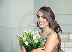 Portrait of woman with white flowers. Young girl with a bright make-up