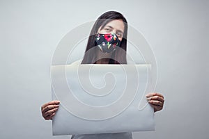 Portrait of woman with white sign and face mask photo