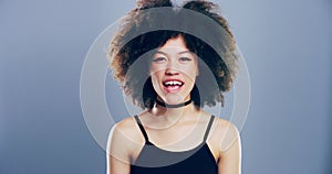 Portrait, woman with wink and afro in studio for like, opportunity or secret deal agreement gesture. Flirt emoji