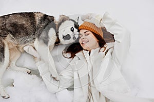 portrait of a woman winter clothes walking the dog in the snow fresh air