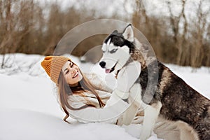 portrait of a woman winter clothes walking the dog in the snow Lifestyle