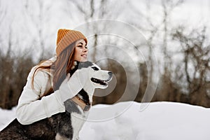 portrait of a woman winter clothes walking the dog in the snow winter holidays