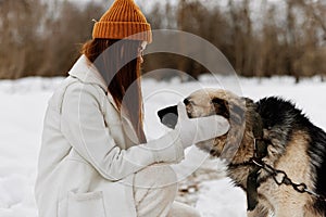 portrait of a woman winter clothes walking the dog in the snow winter holidays