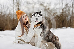 portrait of a woman winter clothes walking the dog in the snow winter holidays