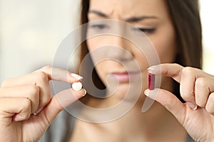 Woman wondering about pill or capsule photo