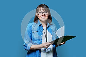 Portrait of woman worker with industrial center card clipboard, on blue background