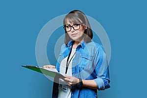 Portrait of woman worker with industrial center card clipboard, on blue background