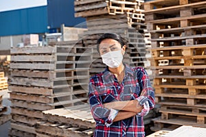 Portrait of woman worker in mask posing at warehouse