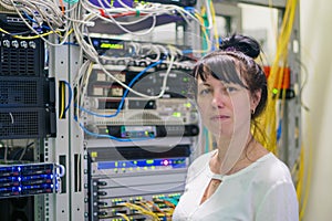 Portrait of a woman working as a system administrator in an Internet provider company. The girl is on a background of powerful