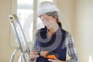 portrait woman working with drill