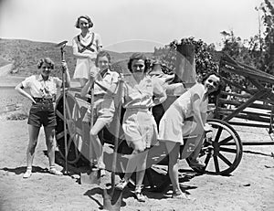 Portrait of women with agricultural tools