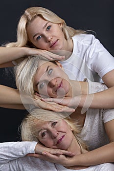 Portrait of women of different ages of the same family on a black background. Close-up. Love and tenderness. Vertical