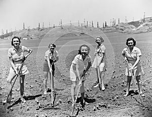 Portrait of women digging in field