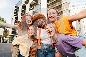 Portrait of a only women group smiling and having fun together. Excited females looking at camera with friendly