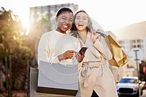 Portrait, women and paper bag with smartphone for online shopping, sale or retail together outdoor by mall. Happy people