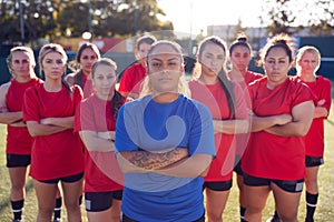 Portrait Of Womens Football Team With Manager Training For Soccer Match On Outdoor Astro Turf Pitch