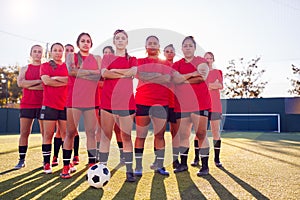 Portrait Of Womens Football Team Training For Soccer Match On Outdoor Astro Turf Pitch photo