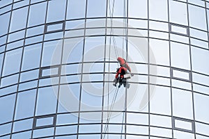portrait of a worker cleaning the windows of a modern building.