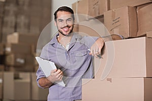 Portrait of worker with clipboard in warehouse